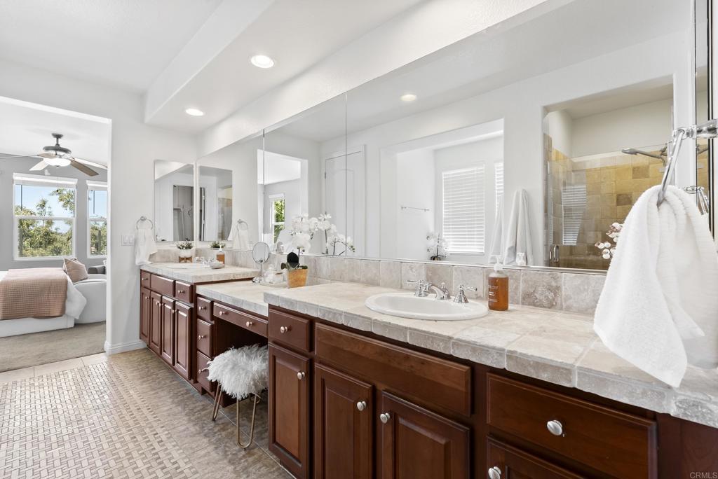 1407 Eclipse Drive San Marcos, CA 92078 - Photo 15 of 32 a spacious bathroom with a granite countertop double vanity sink and a mirror