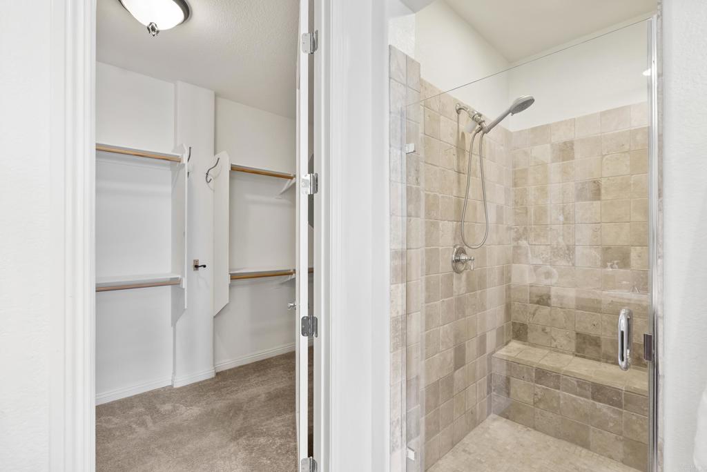 1407 Eclipse Drive San Marcos, CA 92078 - Photo 17 of 32 a bathroom with a shower and a glass door