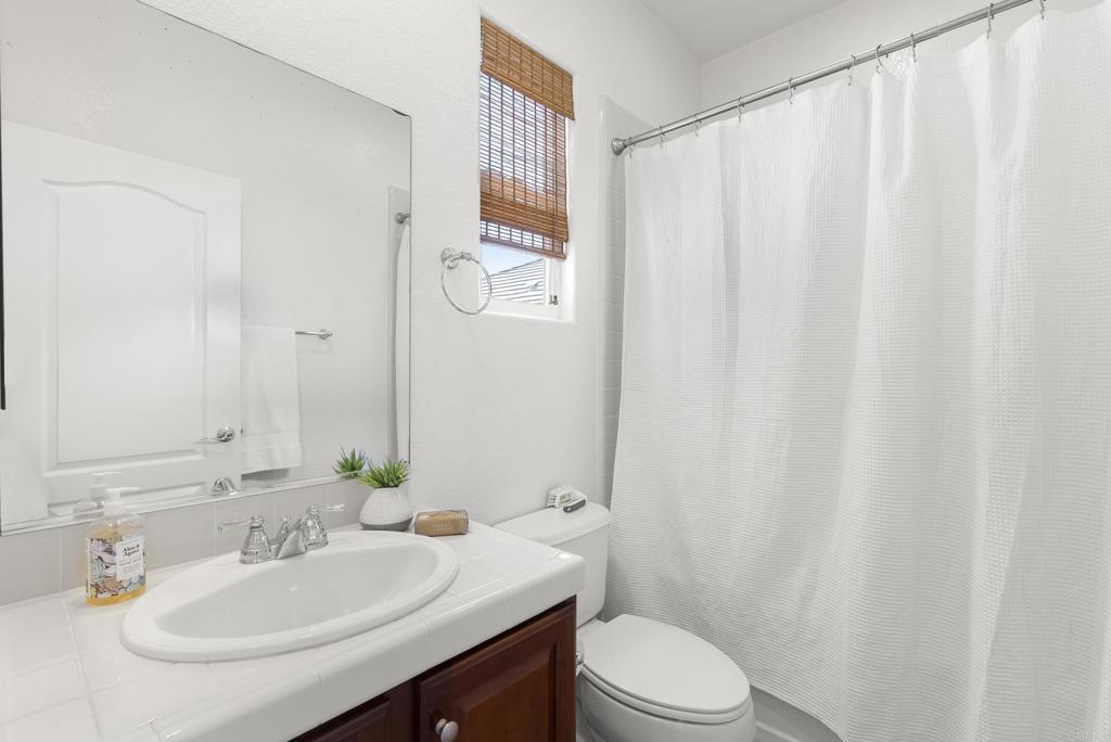 1407 Eclipse Drive San Marcos, CA 92078 - Photo 21 of 32 a bathroom with a sink toilet and a mirror