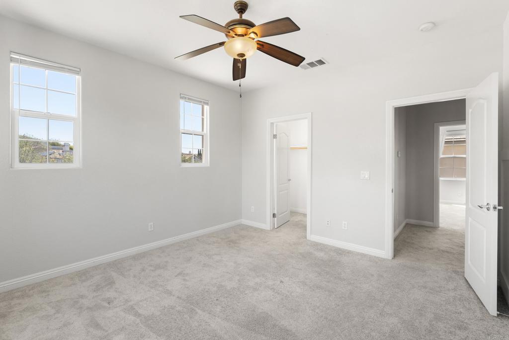 1407 Eclipse Drive San Marcos, CA 92078 - Photo 23 of 32 a view of room with chandelier fan and windows