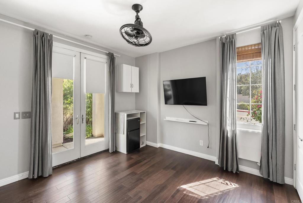 1407 Eclipse Drive San Marcos, CA 92078 - Photo 27 of 32 a living room with hardwood floor and a flat screen tv