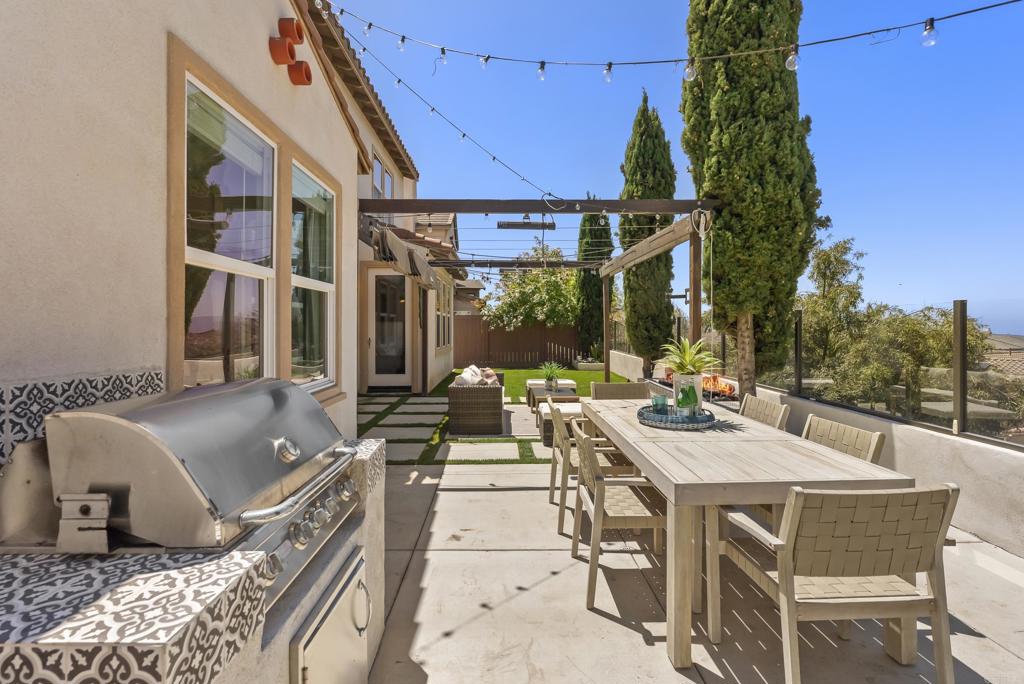 1407 Eclipse Drive San Marcos, CA 92078 - Photo 30 of 32 a view of a patio with couches table and chairs and potted plants