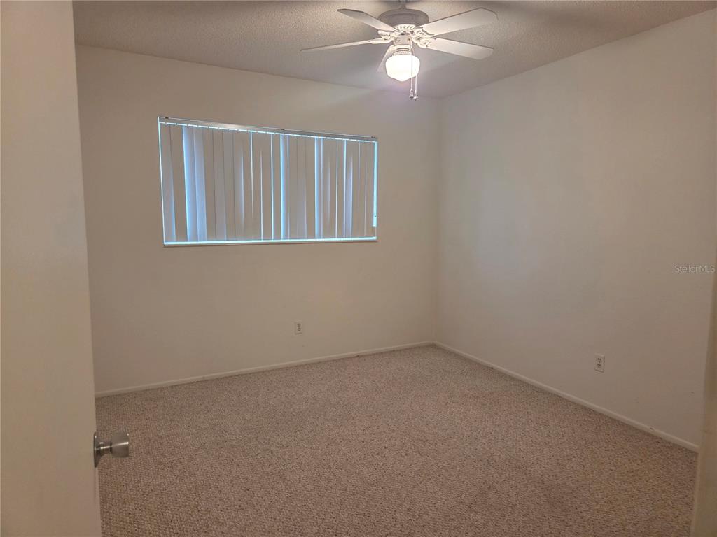 2386 Sumatran Way, Unit 14 Clearwater, FL 33763 - Photo 23 of 71 a view of an empty room with a window