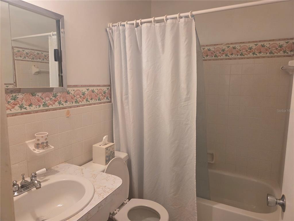 2386 Sumatran Way, Unit 14 Clearwater, FL 33763 - Photo 24 of 71 a bathroom with a sink toilet and shower