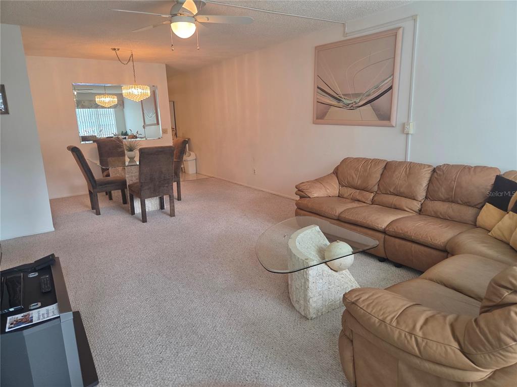 2386 Sumatran Way, Unit 14 Clearwater, FL 33763 - Photo 6 of 71 a living room with furniture and a chandelier