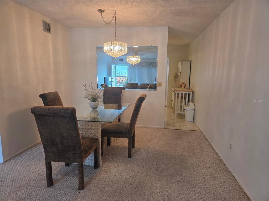 2386 Sumatran Way, Unit 14 Clearwater, FL 33763 - Photo 8 of 71 a view of a dining room with furniture and chandelier