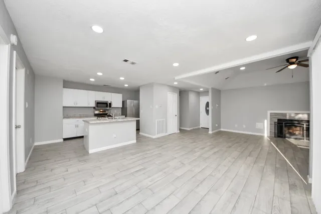 a view of kitchen with refrigerator sink and stove