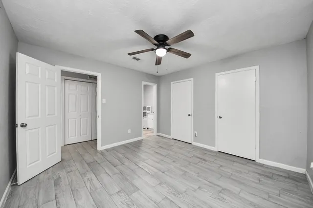 a view of an empty room and wooden floor
