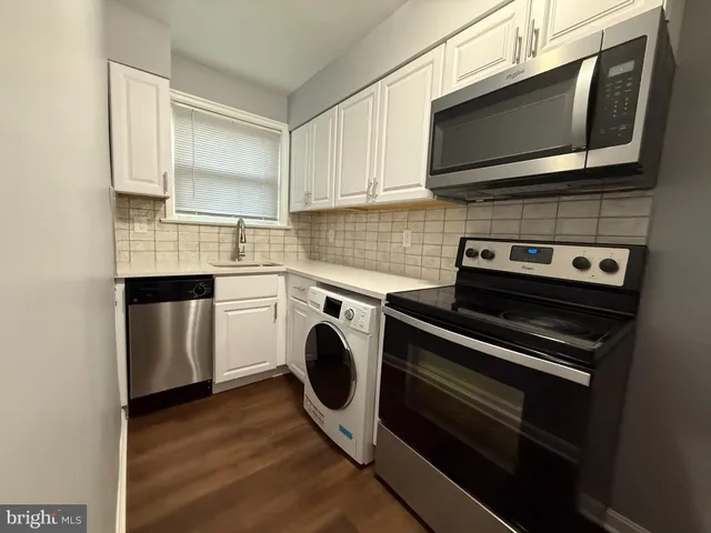 a kitchen with a stove and a microwave