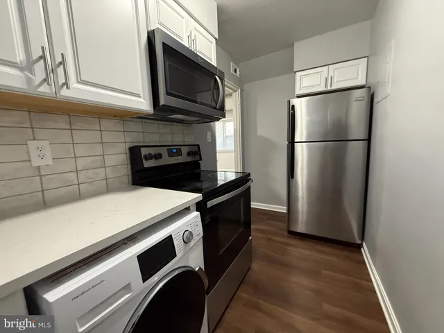 a kitchen with appliances and cabinets