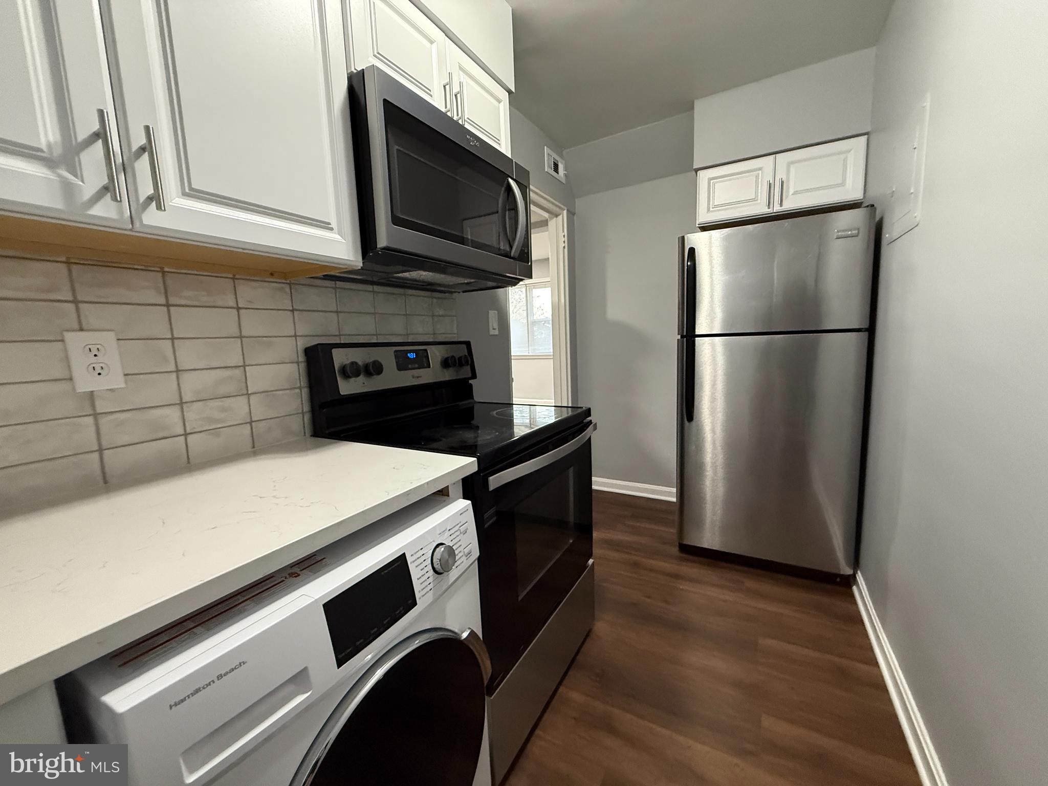 3043 Patrick Henry Drive, Unit 302 Falls Church, VA 22044 - Photo 4 of 7 a kitchen with appliances and cabinets