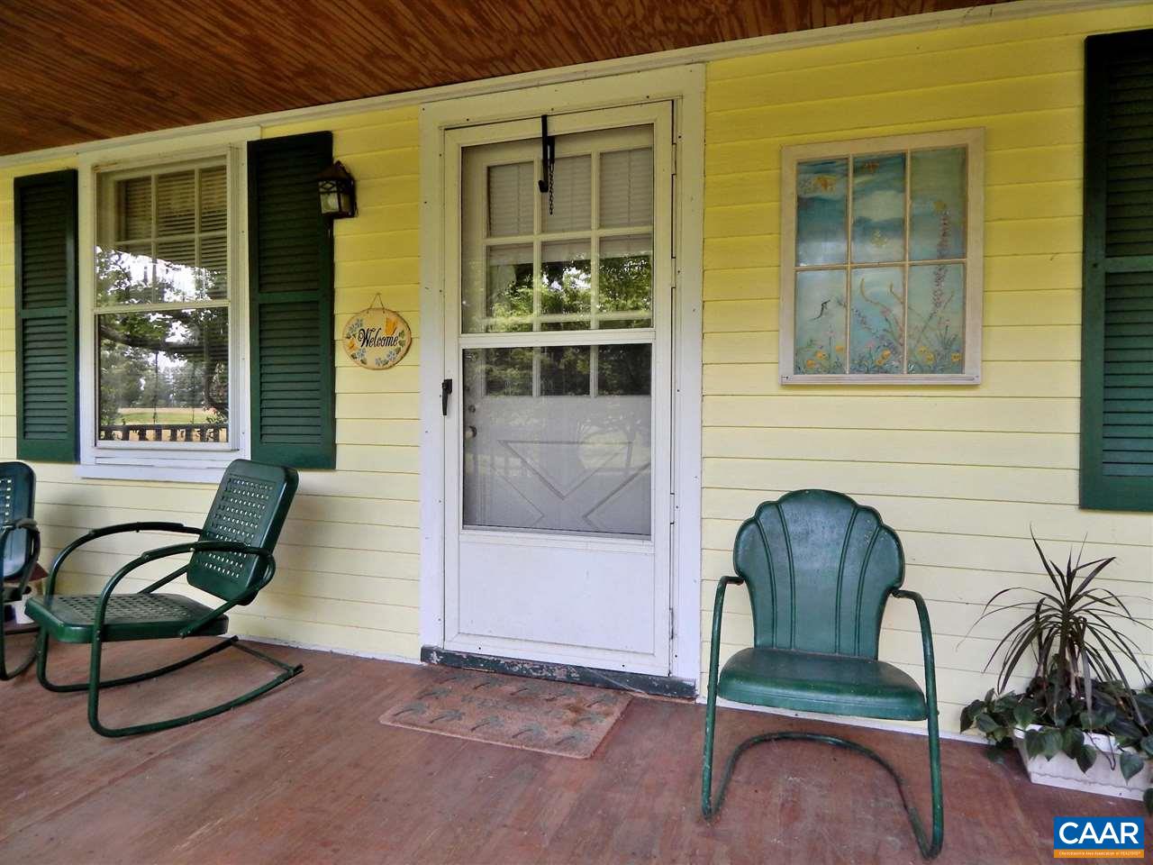 5298 Poindexter Road Louisa, VA 23093 - Photo 8 of 20 a front view of a house with glass windows and outdoor seating