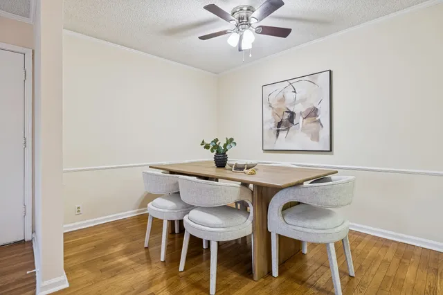a view of a dining room with furniture and wooden floor