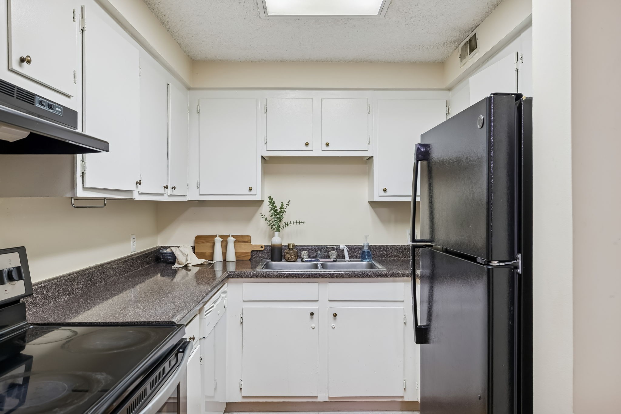 500 Paragon Mills Road, Unit M11 Nashville, TN 37211 - Photo 16 of 31 a kitchen with stainless steel appliances granite countertop a refrigerator a sink and white cabinets