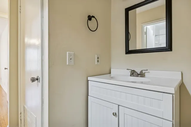 a bathroom with a sink vanity and a mirror