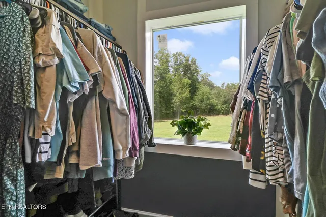 a view of walk in closet with clothes