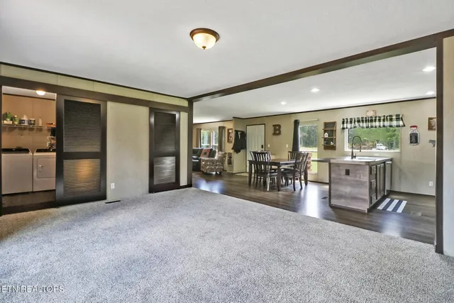 a view of a livingroom with furniture and a refrigerator