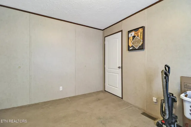 a kitchen with stainless steel appliances granite countertop a refrigerator a stove a sink a dining table and chairs