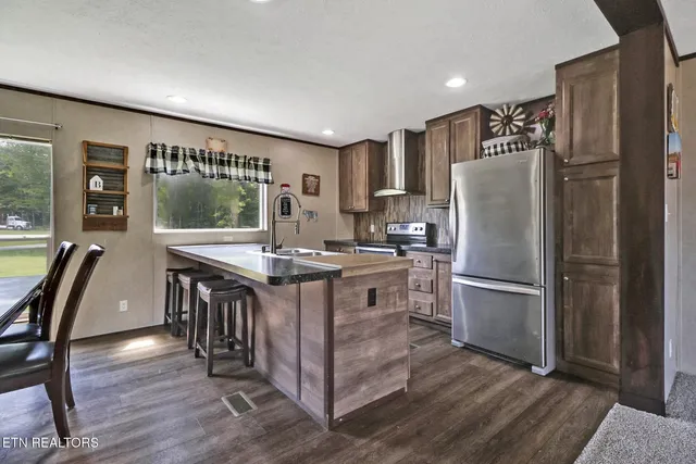 a kitchen with granite countertop a sink and a refrigerator