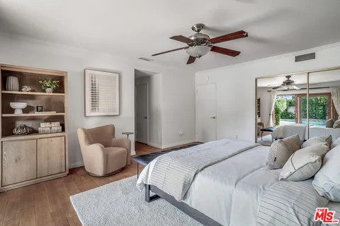a bedroom with a bed and a painting on the wall