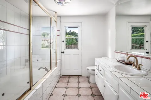 a bathroom with a shower and a toilet