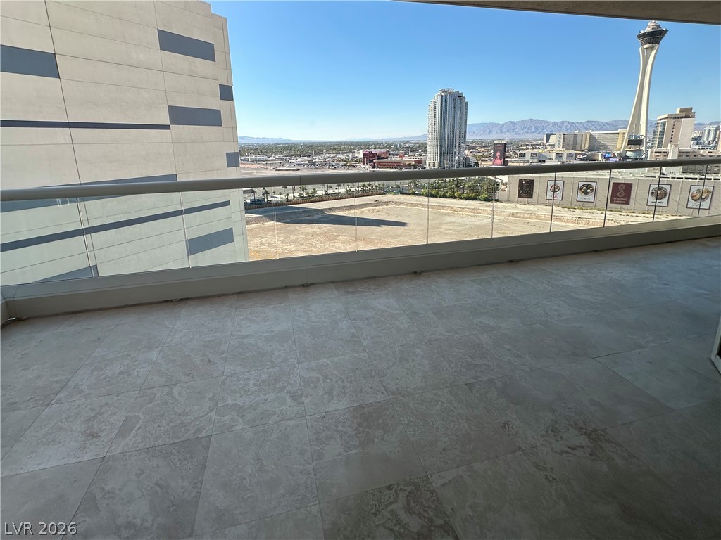 2747 Paradise Road, Unit 1706 Las Vegas, NV 89109 - Photo 26 of 35 Cityscape views unfold from this balcony, showcasing surrounding architecture and distant mountains.