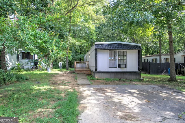 a view of backyard of house with green space