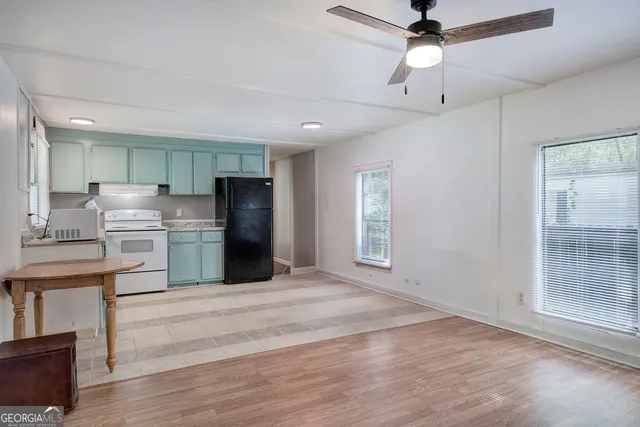a kitchen with stainless steel appliances a refrigerator sink and cabinets