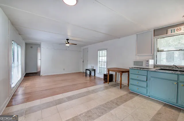 a kitchen with a sink cabinets and window