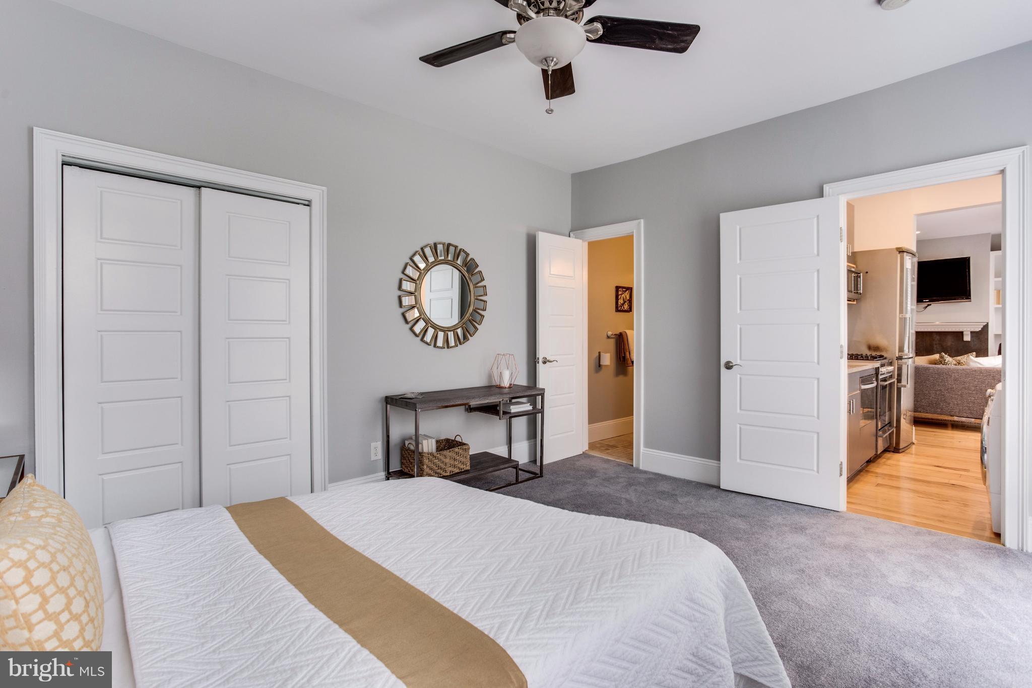 1523 Park Road Northwest, Unit 202 Washington, DC 20010 - Photo 11 of 13 a bedroom with a bed and a chandelier