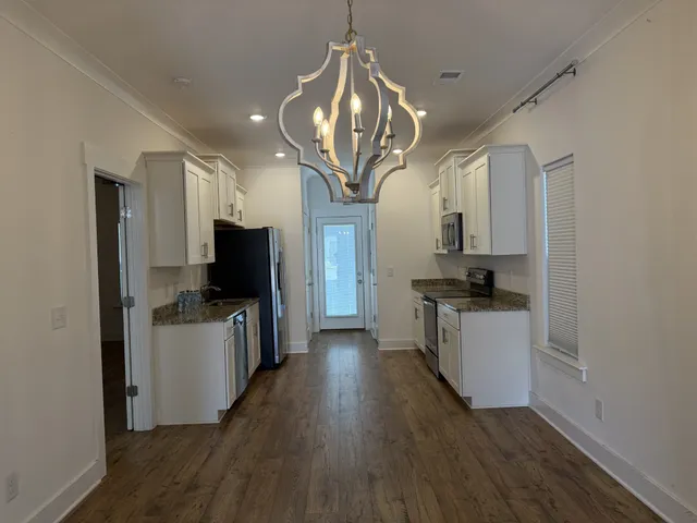 a view of a kitchen from the hallway
