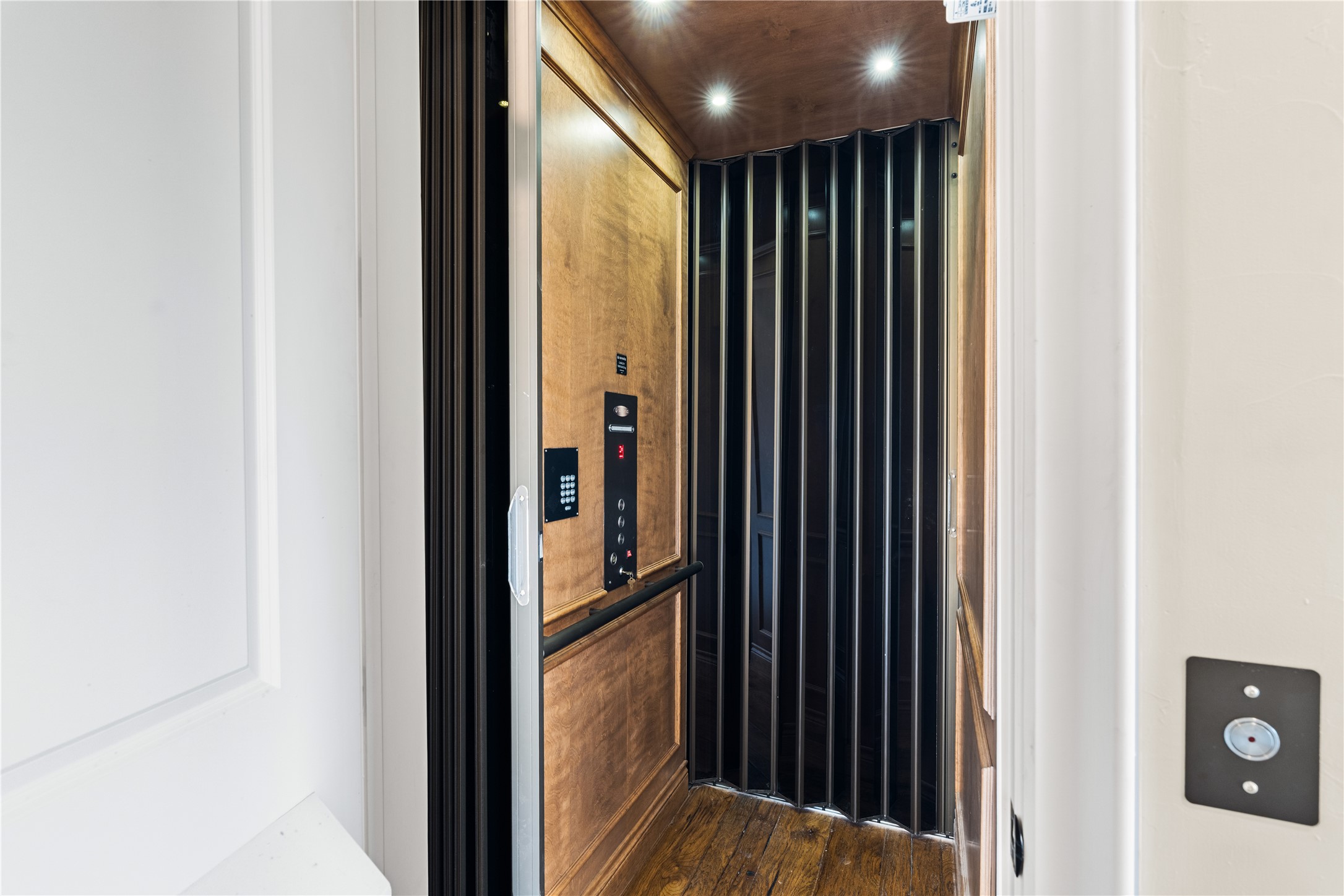 12349 Longmire Trace Conroe, TX 77304 - Photo 21 of 48 Private in-home elevator with warm wood paneling and recessed lighting for effortless multi-level living.