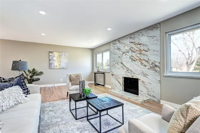 a living room with furniture a fireplace and a flat screen tv