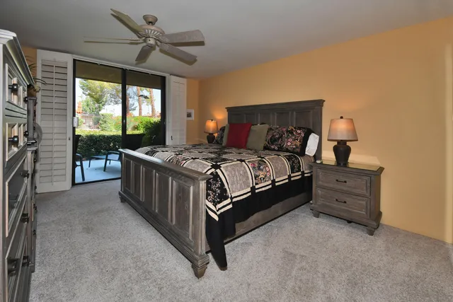 a bedroom with a bed and a dresser next to a window