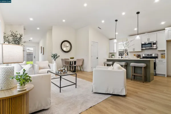 a living room with kitchen island furniture and a wooden floor