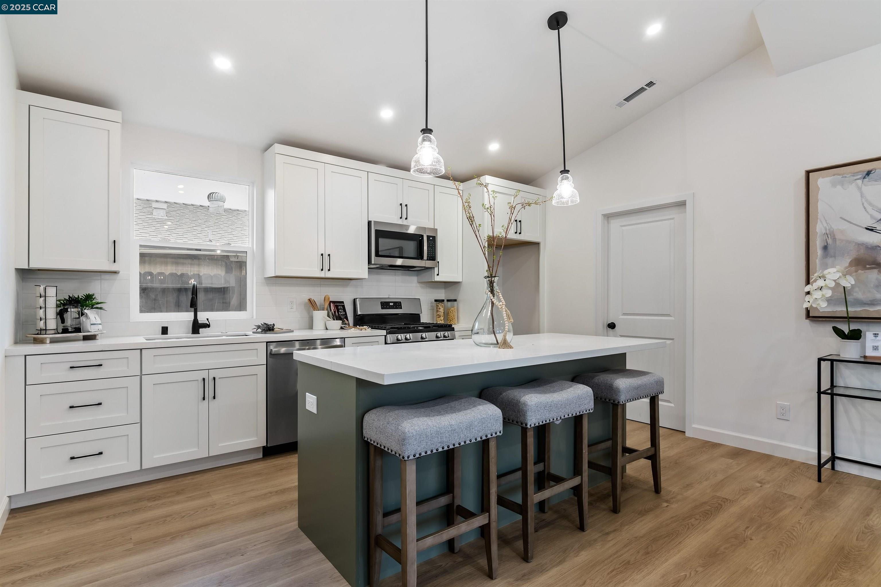 330 Warren Way Pittsburg, CA 94565 - Photo 14 of 37 a kitchen with kitchen island granite countertop a sink counter and chairs