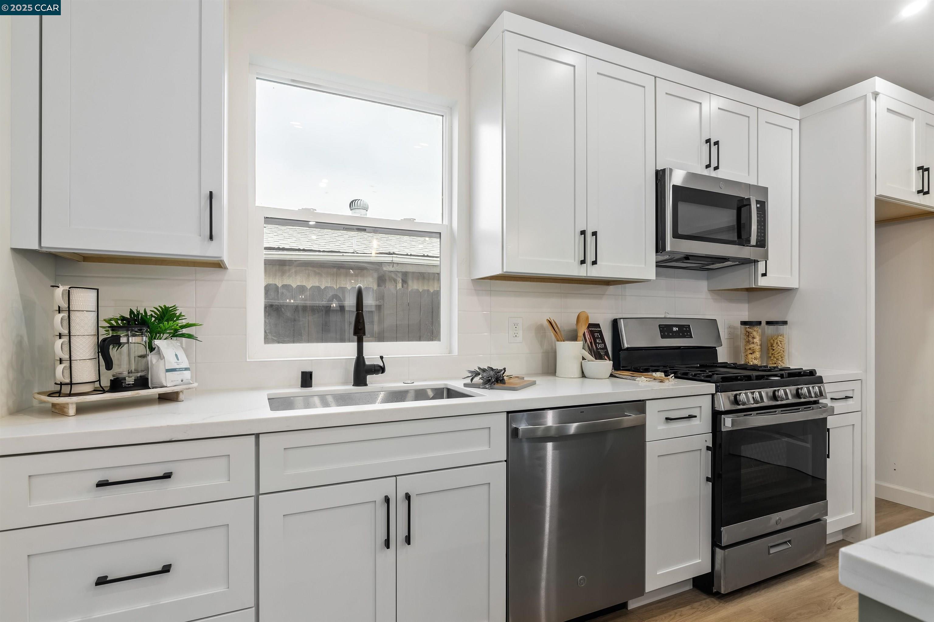 330 Warren Way Pittsburg, CA 94565 - Photo 19 of 37 a kitchen with white cabinets and white appliances