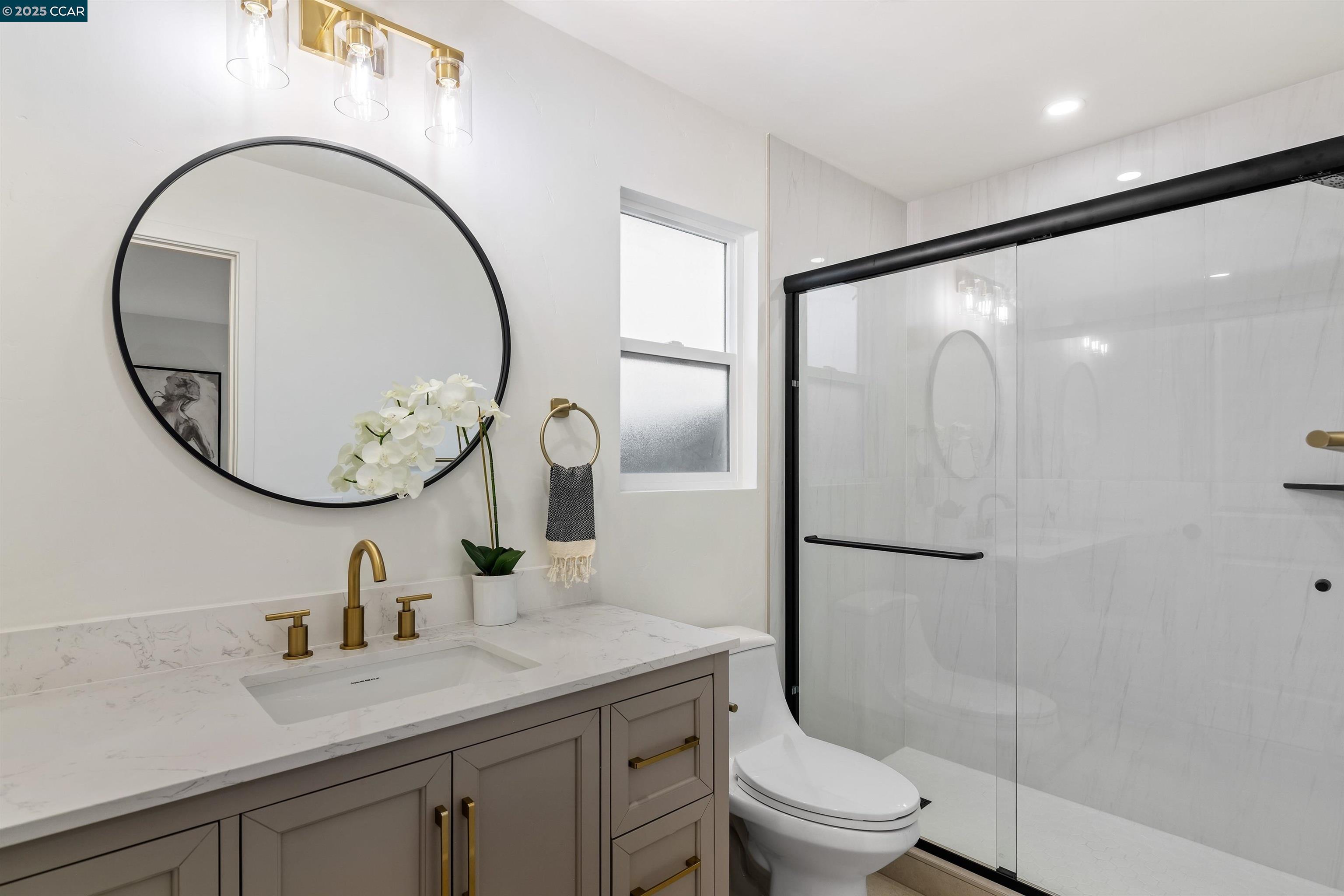 330 Warren Way Pittsburg, CA 94565 - Photo 25 of 37 a bathroom with a toilet a sink and a mirror