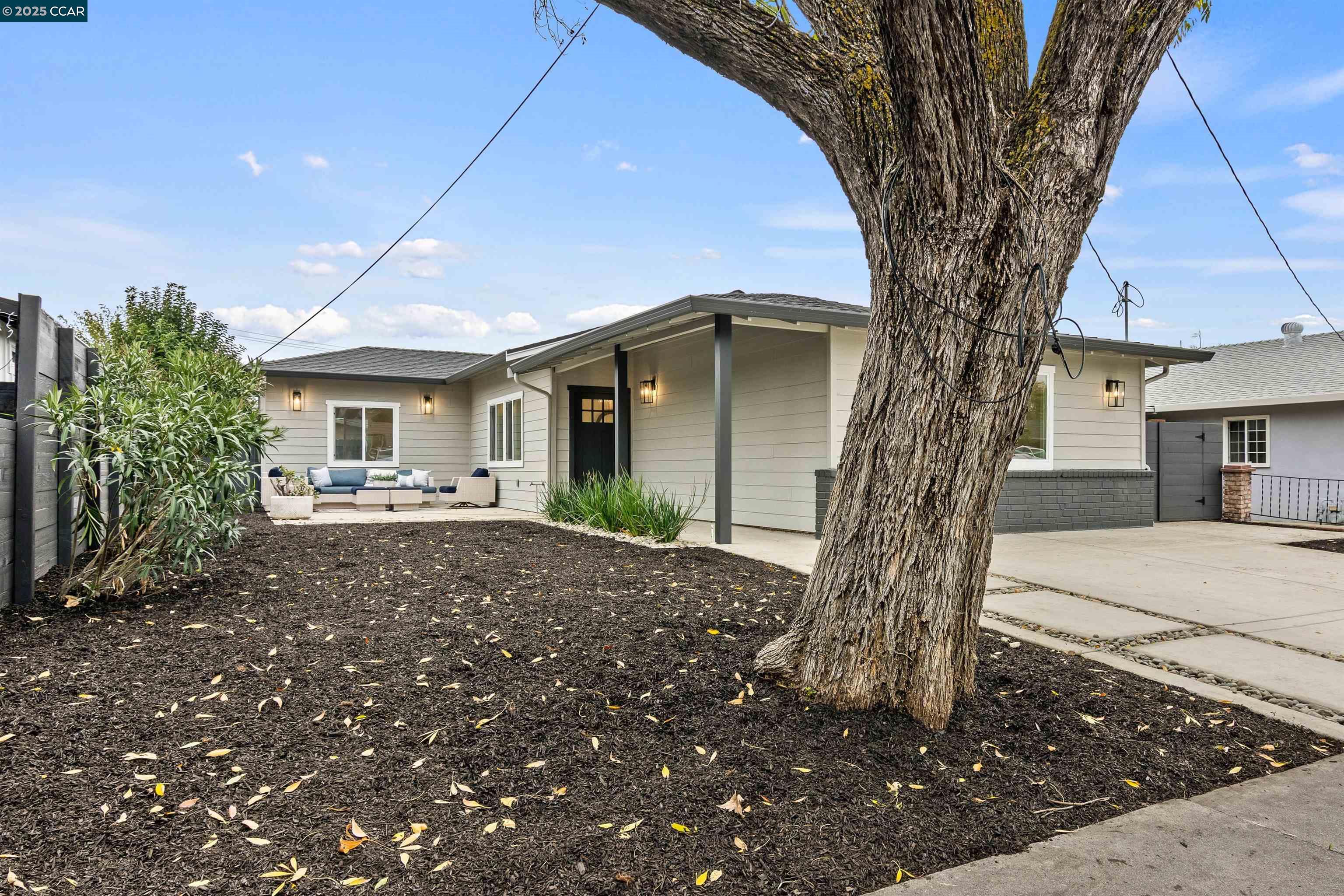 330 Warren Way Pittsburg, CA 94565 - Photo 3 of 37 a front view of a house with a tree