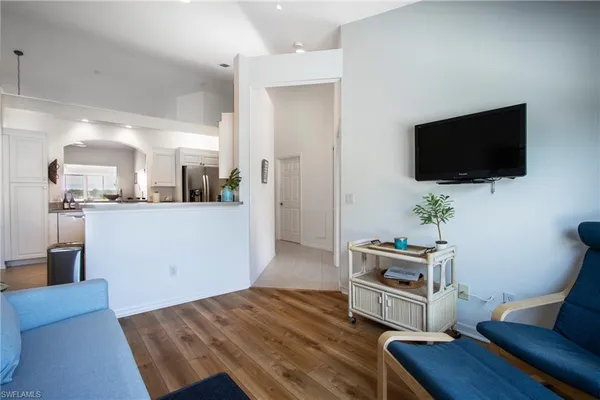 a view of a livingroom with furniture and a flat screen tv