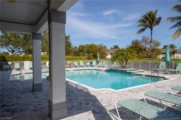 a view of a swimming pool with an outdoor seating