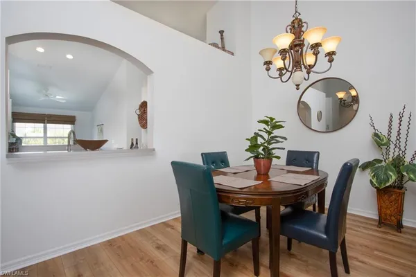 a dining room with furniture and wooden floor