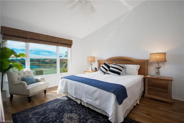 a bedroom with a bed and glass window