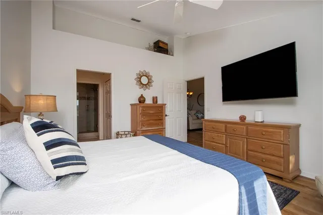 a bedroom with a bed and flat screen tv