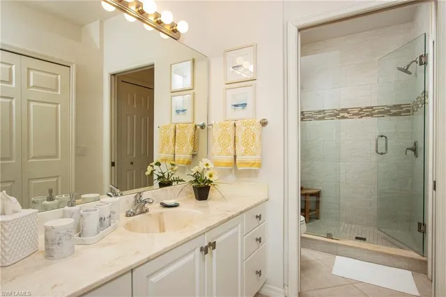a bathroom with a double vanity sink mirror and shower