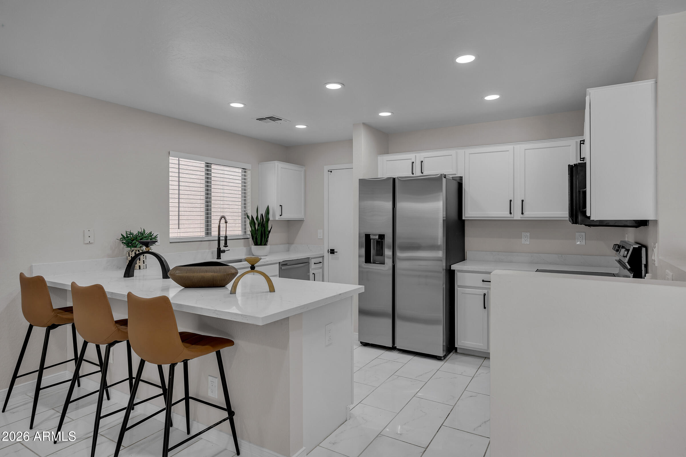 5725 East Good Pasture Lane Florence, AZ 85132 - Photo 13 of 40 a kitchen with refrigerator and chairs