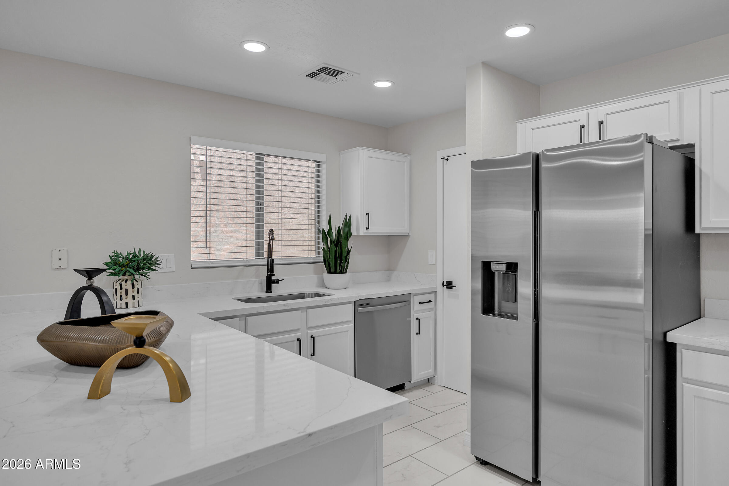 5725 East Good Pasture Lane Florence, AZ 85132 - Photo 15 of 40 a kitchen with stainless steel appliances a sink a counter and a refrigerator