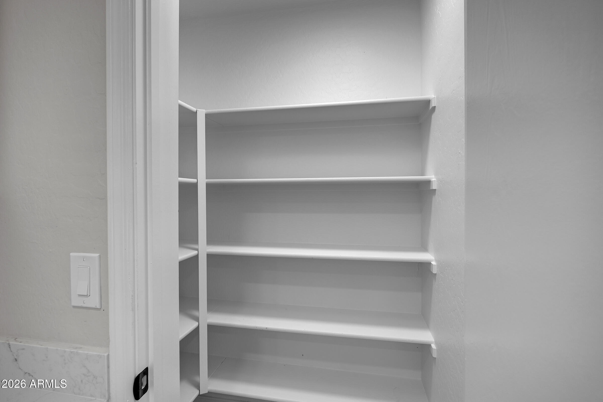 5725 East Good Pasture Lane Florence, AZ 85132 - Photo 18 of 40 a view of walk in closet with empty racks