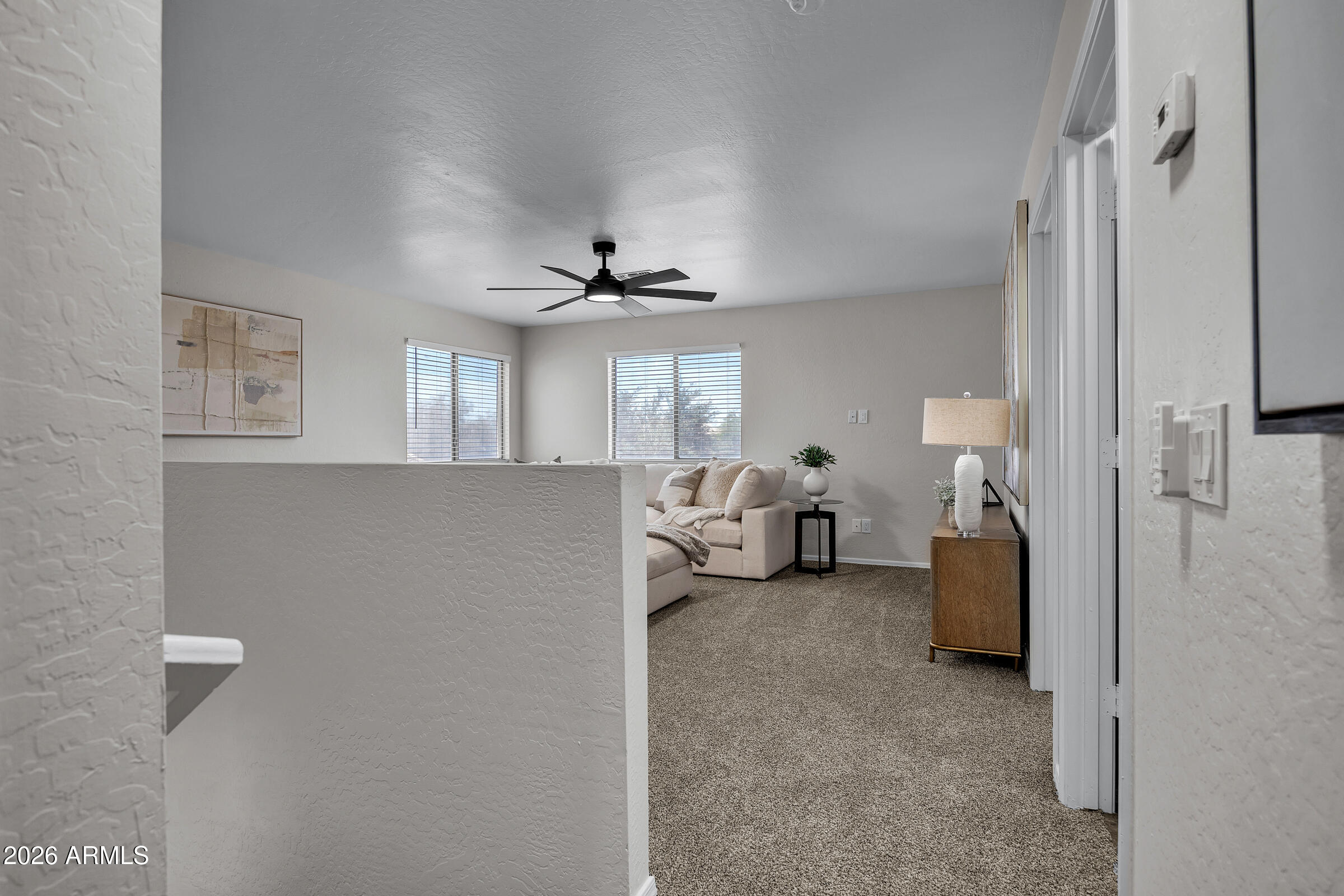 5725 East Good Pasture Lane Florence, AZ 85132 - Photo 19 of 40 a view of a livingroom with furniture and a ceiling fan