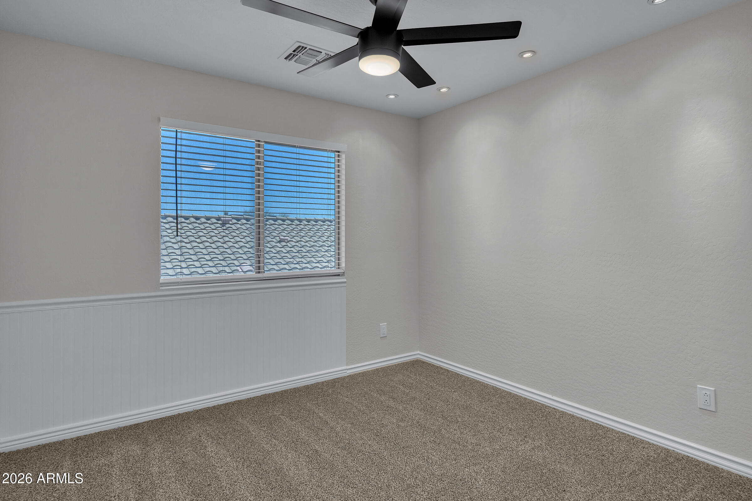 5725 East Good Pasture Lane Florence, AZ 85132 - Photo 24 of 40 an empty room with a window and a fan